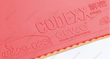 A close-up of a red table tennis rubber with embossed branding and model text, including GEWO, CODEXX EF PRO 54, and the German mark. The rubber is shown against a white background with a diagonal cutaway revealing the inner layer.