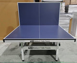 Blue table tennis table with 'Rodney's Table Tennis' branding in an indoor setting.