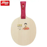 A table tennis paddle blade with a red handle and a printed portrait of Ma Long with 'GRAND SLAN' text on the face. A red DHS logo is visible in the top-left corner.
