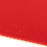 Close-up of a red VICTAS table tennis paddle surface showing embossed text including 'V>15 Sticky soft', 'MADE IN GERMANY', and the VICTAS logo.