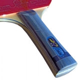 Close-up of a table tennis racket with a blue handle and red top, on a white background.